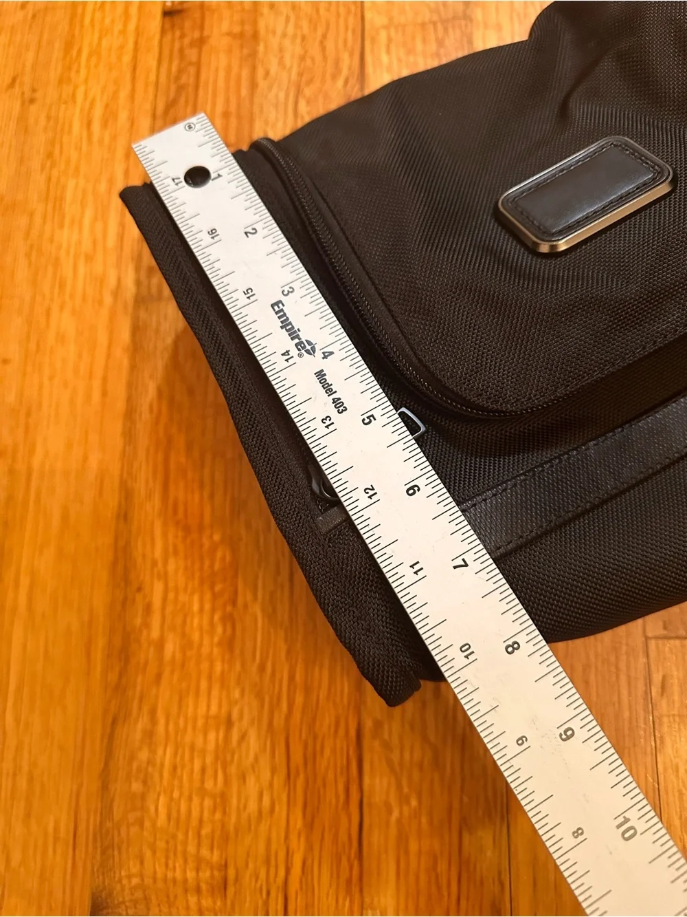 Tumi hanging travel kit with hook for hanging.